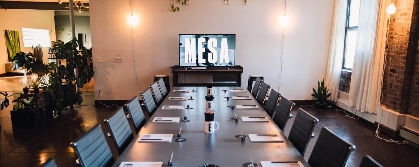 A Mesa table prepared for a team session, with a screen that reads MESA